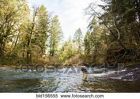 Caucasian fisherman fly-fishing in river View Large Photo Image Stock Photography - Caucasian fisherman fly-fishing in river. Fotosearch