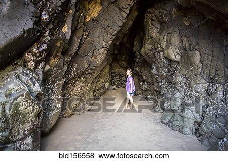 Caucasian girl exploring cave at beach View Large Photo Image Stock Photo - Caucasian girl exploring cave at beach. Fotosearch