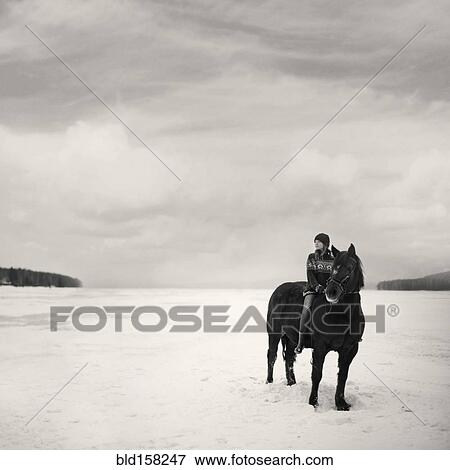 Caucasian girl riding horse in snowy field View Large Photo Image Stock Photo - Caucasian girl riding horse in snowy field. Fotosearch
