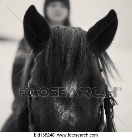 Stock Photo - Caucasian girl riding horse outdoors. Fotosearch