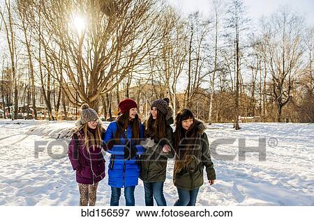 Caucasian girls arm in arm in snowy field View Large Photo Image Stock Photo - Caucasian girls arm in arm in snowy field. Fotosearch