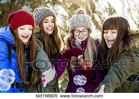 Caucasian girls blowing bubbles outdoors in winter View Large Photo Image Stock Photography - Caucasian girls blowing bubbles outdoors in winter. Fotosearch