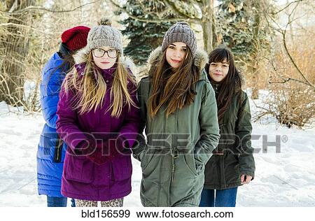 Stock Photo - Caucasian girls standing in snowy field. Fotosearch