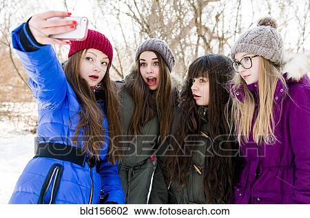 Caucasian girls taking cell phone photograph in snowy field View Large Photo Image Stock Image - Caucasian girls taking cell phone photograph in snowy field. Fotosearch