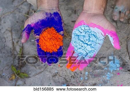 Stock Photography - Caucasian man holding colorful paint powder. Fotosearch
