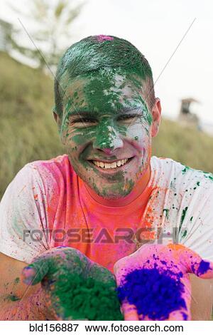 Caucasian man splattered with paint powder showing hands View Large Photo Image Stock Photo - Caucasian man splattered with paint powder showing hands. Fotosearch