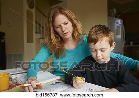 Stock Photo - Caucasian mother helping son do homework. Fotosearch