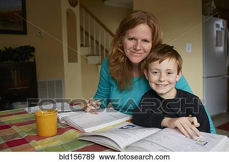 Stock Photo - Caucasian mother helping son do homework. Fotosearch