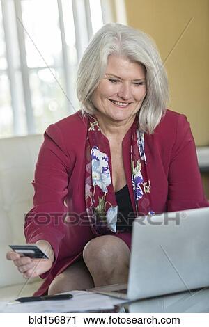 Caucasian older woman shopping online View Large Photo Image Stock Image - Caucasian older woman shopping online. Fotosearch