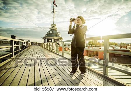 Caucasian tourist using camera on boardwalk View Large Photo Image Stock Photo - Caucasian tourist using camera on boardwalk. Fotosearch