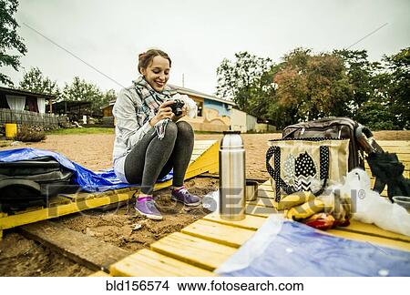 Caucasian woman admiring photographs at picnic View Large Photo Image Picture - Caucasian woman admiring photographs at picnic. Fotosearch