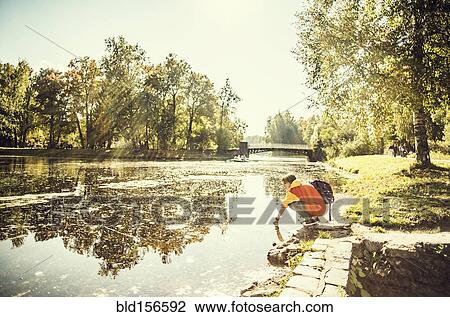 Caucasian woman dipping hand in park pond View Large Photo Image Stock Image - Caucasian woman dipping hand in park pond. Fotosearch