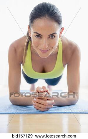 Caucasian woman exercising on yoga mat View Large Photo Image Stock Photo - Caucasian woman exercising on yoga mat. Fotosearch