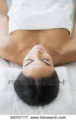 Stock Photo - Caucasian woman laying on massage table. Fotosearch