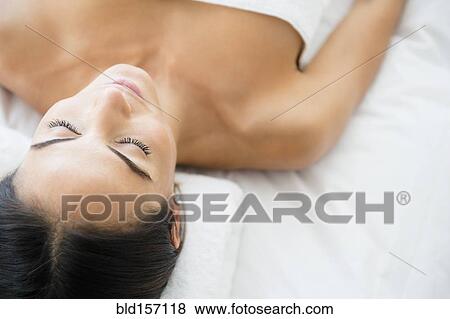 Stock Photo - Caucasian woman laying on massage table. Fotosearch