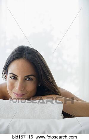 Stock Photograph - Caucasian woman laying on massage table. Fotosearch