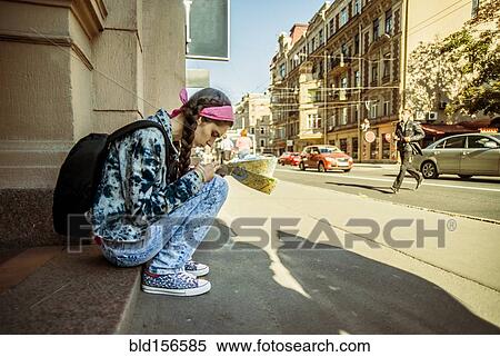 Stock Photography - Caucasian woman reading map in Ykaterinberg, Ural, Russia. Fotosearch