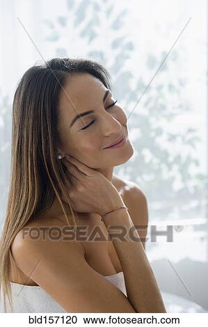 Caucasian woman rubbing her neck on massage table View Large Photo Image Stock Image - Caucasian woman rubbing her neck on massage table. Fotosearch