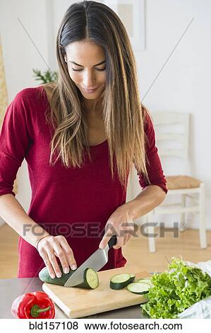 Caucasian woman slicing vegetables for salad View Large Photo Image Stock Photo - Caucasian woman slicing vegetables for salad. Fotosearch