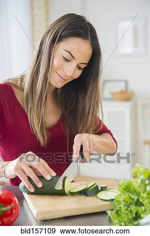 Caucasian woman slicing vegetables for salad View Large Photo Image Stock Photo - Caucasian woman slicing vegetables for salad. Fotosearch