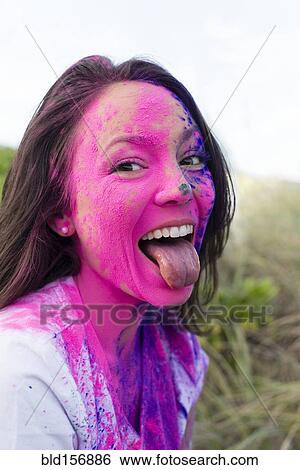 Caucasian woman splattered with paint powder with tongue out View Large Photo Image Stock Photograph - Caucasian woman splattered with paint powder with tongue out. Fotosearch