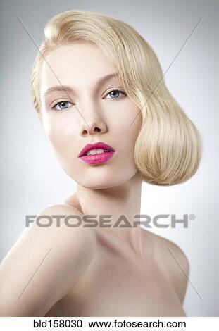 Stock Image - Caucasian woman with glamorous hairstyle and makeup. Fotosearch