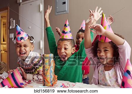 Stock Photo - Children cheering at party. Fotosearch
