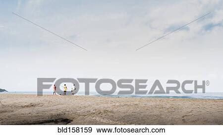 Children playing on beach under cloudy sky View Large Photo Image Stock Photo - Children playing on beach under cloudy sky. Fotosearch