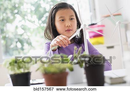 Stock Photo - Chinese student examining model wind turbine in science lab. Fotosearch