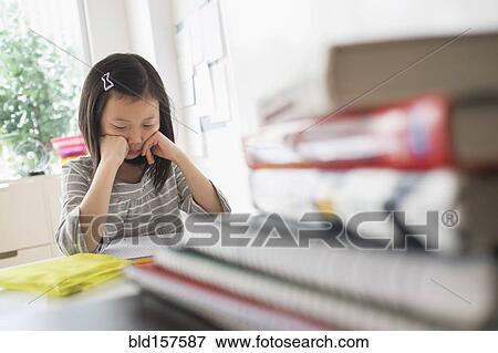 Chinese student thinking about homework View Large Photo Image Stock Photo - Chinese student thinking about homework. Fotosearch