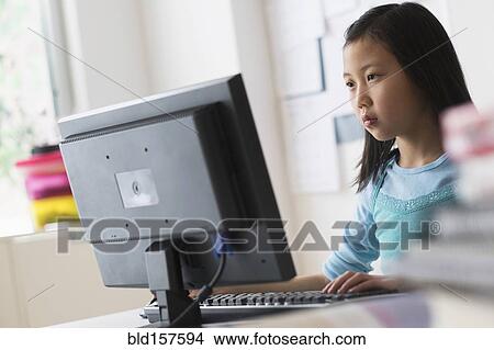 Picture - Chinese student using desktop computer. Fotosearch