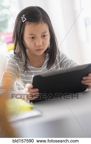 Chinese student using digital tablet View Large Photo Image Stock Image - Chinese student using digital tablet. Fotosearch