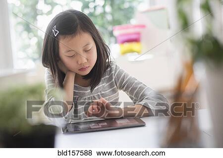 Stock Photo - Chinese student using digital tablet. Fotosearch