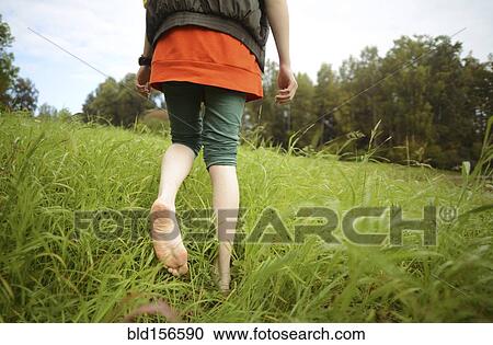 Close up of barefoot Caucasian woman walking in park View Large Photo Image Stock Image - Close up of barefoot Caucasian woman walking in park. Fotosearch