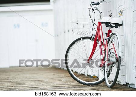 Close up of bicycle leaning on white wall View Large Photo Image Stock Image - Close up of bicycle leaning on white wall. Fotosearch