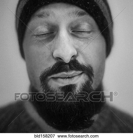 Stock Photo - Close up of Caucasian man smiling with eyes closed. Fotosearch