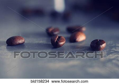 Picture - Close up of coffee beans on table. Fotosearch