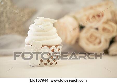 Picture - Close up of decorated cupcake with white icing. Fotosearch