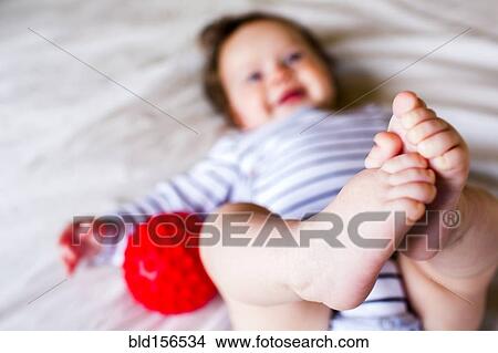 Picture - Close up of feet of Caucasian baby girl. Fotosearch