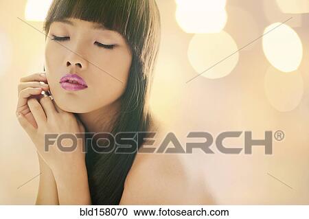Stock Image - Close up of glamorous woman with eyes closed. Fotosearch