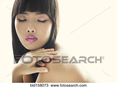 Stock Image - Close up of glamorous woman with eyes closed. Fotosearch