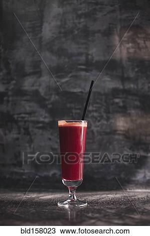 Stock Image - Close up of glass of healthy red juice. Fotosearch