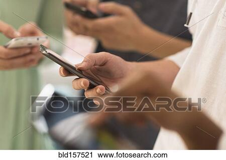 Close up of hands texting on cell phones View Large Photo Image Stock Image - Close up of hands texting on cell phones. Fotosearch