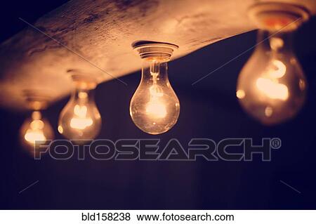 Stock Photo - Close up of illuminated light bulbs at night. Fotosearch