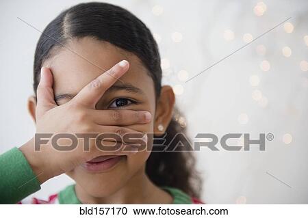 Close up of mixed race girl peeking between fingers View Large Photo Image Stock Image - Close up of mixed race girl peeking between fingers. Fotosearch