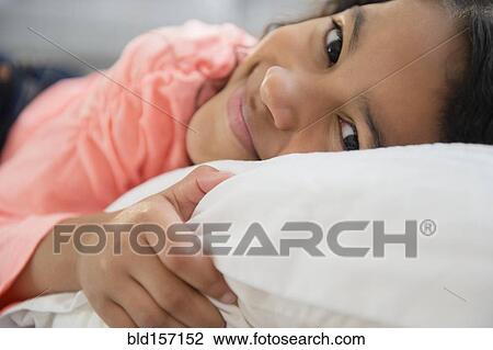 Close up of mixed race girl smiling on pillow View Large Photo Image Stock Image - Close up of mixed race girl smiling on pillow. Fotosearch