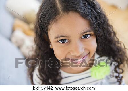 Stock Image - Close up of mixed race girl smiling. Fotosearch