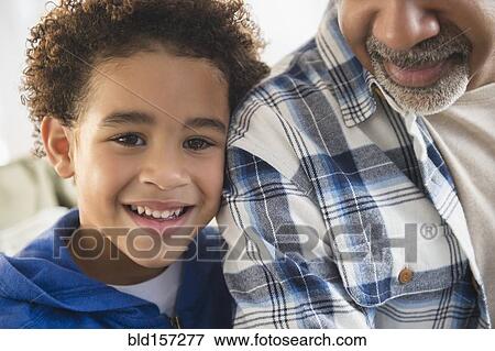 Stock Photo - Close up of mixed race grandfather and grandson smiling. Fotosearch