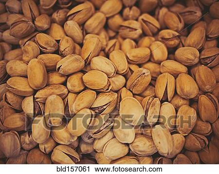Stock Image - Close up of pile of pistachios. Fotosearch