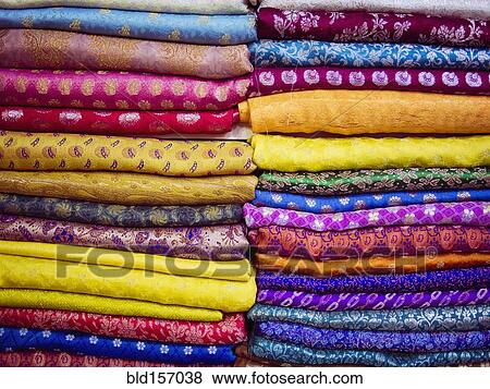 Stock Photo - Close up of piles of multicolor fabrics. Fotosearch